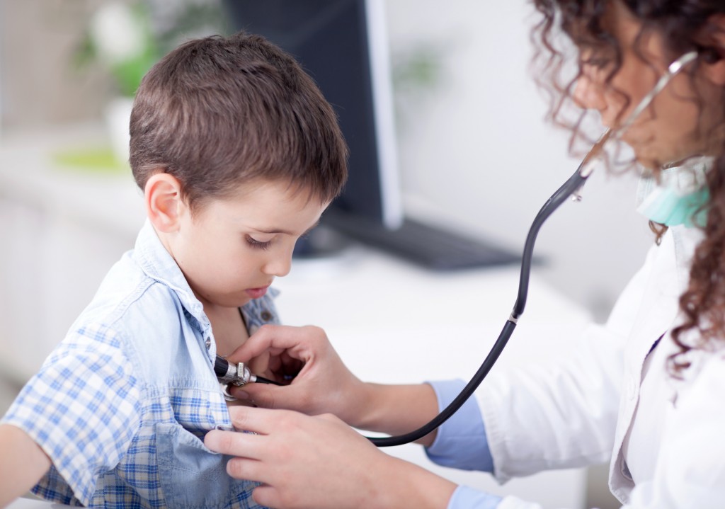 friendly female doctor examining a little boy
